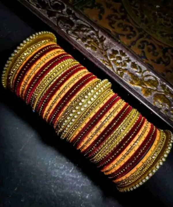 Main image showcasing the Elegant Peach and Maroon Chuda, wrapped in vibrant silk thread and adorned with sparkling white stones.