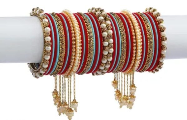 Right angle view of the Elegant Red and Light Blue Gold-Plated Pearl Studded Kada, showcasing the intricate pearl embellishments and vibrant velvet bangles.