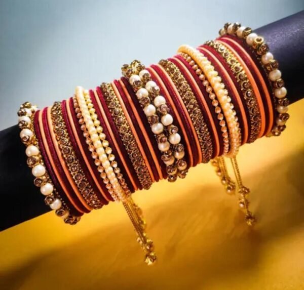 Right angle view of the Maroon & Peach Gold-Plated Pearl Studded Kada, showcasing intricate pearl embellishments and velvet bangles.