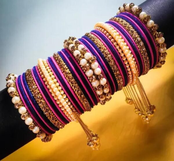 Right angle view of the Elegant Deep Pink and Purple Gold-Plated Pearl Studded Kada, showcasing intricate pearl embellishments and velvet bangles.