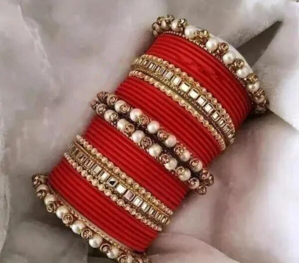 Main image showcasing the Red Kundan Stone and Pearls Bangles Set, featuring intricate kundan and pearl work on a durable metal base, perfect for ethnic wear and special occasions.
